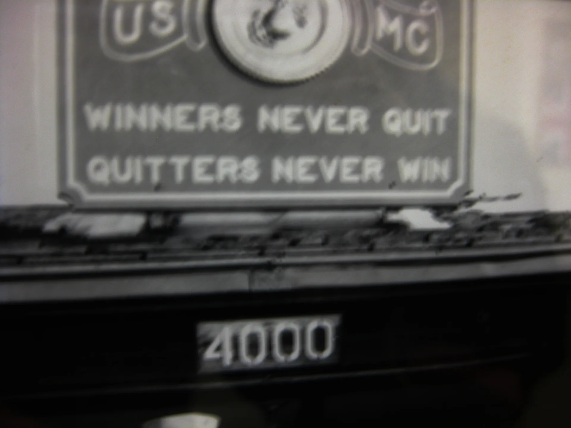 A Marine Corps sign reading Winners never quit, quitters never win